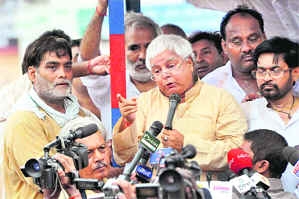 RJD chief Lalu Prasad addresses mediapersons during the Bihar bandh, in Patna on Saturday