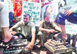 Ex-servicemen stage a protest by polishing shoes in Amritsar