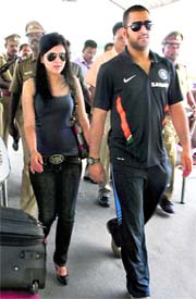 Indian captain M S Dhoni and his wife Sakshi at Chennai airport on Saturday before leaving for Sri Lanka for a three-match Test series and a tri-nation ODI series starting July 18.