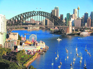 Yachts and ferries under the Harbour Bridge present a fascinating view of Sydney