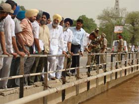 Deputy CM Sukhbir Badal reviewing the flood situation in Sardulgarh in Mansa district on Sunday. Sudden rise in the water level of Ghaggar has threatened the bridge on the main road. 