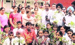 Participants at a tree plantation drive in Dehradun on Sunday.