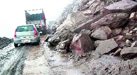 Vehicles cross a landslide-prone stretch on the Rohtang road.