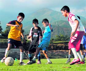 Inspired by the World Cup, children enjoy a football match in Dharamsala on Sunday.