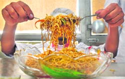 A participant serves noodles during a noodle festival of the Ivanna Institue of Hotel Management in Ludhiana on Sunday. 
