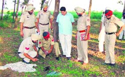 Cops examine the spot near Butahri village where Mewa Singh was killed.