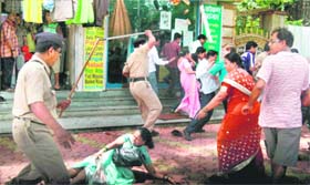 Police personnel cane-charge Shiv Sena activists who were protesting against James Laines book on Shivaji outside Sena Bhawan in Mumbai on Sunday.