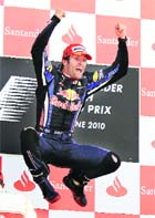 Red Bull driver Mark Webber jumps in the air on the podium as he celebrates his win in Silverstone on Sunday