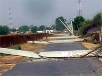 Electric poles were uprooted following heavy rains and duststorm in Abohar on Monday. 