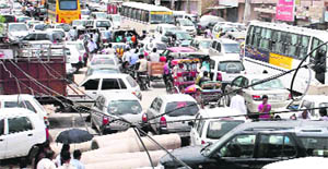 Vehicles get stuck in a traffic jam on a raod in Gurgaon on Monday.