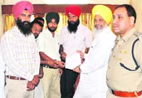 Computer teachers present a memorandum to Hira Singh Gabria (extreme right) in Ludhiana on Monday.