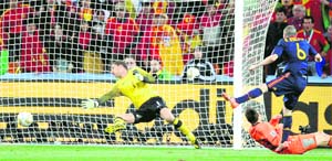 Spains Andres Iniesta (R) scores the winner against Netherlands on Sunday