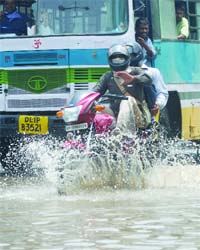 MONSOON MAYHEM: Vehicles ply on a waterlogged road near Rajghat in New Delhi