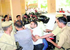 Policemen grapple with vandals at the DCs office in Hisar