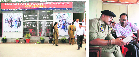 The police assistance booth set up to help and guide Amarnath pilgrims at Kunjwani in Jammu; and (right) a police officer giving information to pilgrims at the booth