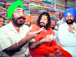 Manmohan Singh, who posed as the PMs adviser, in Mohali on Sunday. Kharar MLA Balbir Singh Sidhu (extreme right) is also seen in the picture