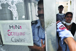 Security guards keep a vigil without using mask in an H1N1 swine flu ward in New Delhi 