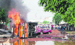 An irate mob sets a truck, which was involved in the accident, on fire at Machgar village in Ballabgarh 