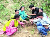 Members of Kaash plant saplings along with villagers at Nishni village in Pauri Garhwal.