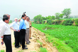 Deputy commissioner PC Meena inspects drain no. 8 at Rohtak.