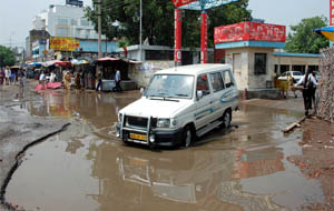 An entrance to the bus stand becomes a pool of water after a light shower in Jalandhar on Thursday.