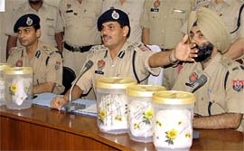 The Commissioner of Police, Ishwar Singh, (centre) addresses the media in Ludhiana on