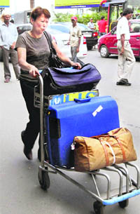 A passenger tries to locate a taxi during a strike called by taxi operators, demanding an increase in the fares, at NSCBI Airport in Kolkata on Thursday.