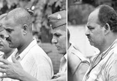 Cops take away Rajesh Yadav (L) and Kripasankar Pandey, both accused of attacking UP minister Nand Gopal Gupta Nandi, in Allahabad on Thursday.