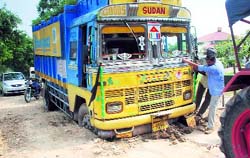 A truck stranded on the damaged link road due to the rains in Fatehgarh Sahib on Thursday