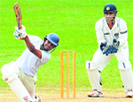Sri Lanka BPXIs Lahiru Thirimanne (L) plays a stroke as Indian captain MS Dhoni (R) looks on during the three-day practice match in Colombo on Thursday.  AFP