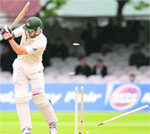 Australias Mitchell Johnson is bowled by Umar Gul