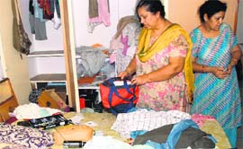 Women look at their ransacked house in Sector 10, Panchkula, on Friday.