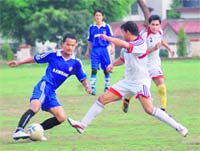 Players vie for the ball during a match at the District Football League in Dehradun on Friday.