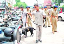 Policemen check vehicles after a hoax bomb call at Paltan Bazar