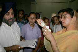 Harsimrat and Sukhbir check price of a medicine at the Civil Hospital in Bathinda.