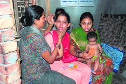 Grieving family members of the victims at their residence.