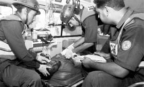 Pakistani rescue workers provide first-aid to an injured victim of bomb blast in Lahore on Saturday.