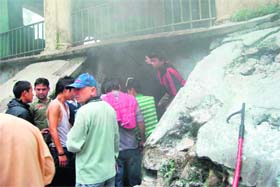 Staff and students of the Central School of Tibetans try to extinguish fire at a sports godown in Mussoorie