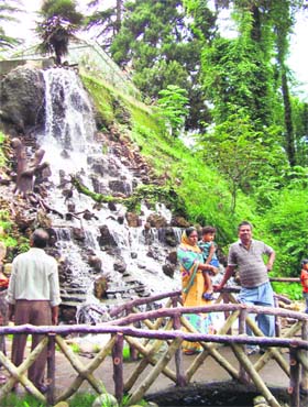 Tourists at a manmade fall at the Company Garden in Mussoorie