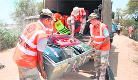 Jawans of the NDRF move material from their truck to be used for rescue operations in a Sirsa village on Sunday.