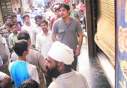 Shopkeepers outside a burgled shop in Rewari on Sunday.