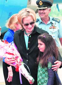 US Secretary of State  Hillary Clinton is greeted by a Pakistan student as she arrives in Islamabad on Sunday.