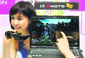 A model poses beside LG Electronics' new 3D computer during the company's product launch in Seoul