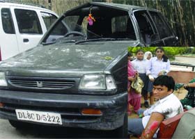 The victim children (inset) and their car at the Tilak Marg police station in New Delhi