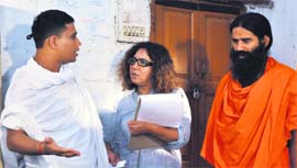 Baba Ramdev, along with Acharya Bala Krishan and film director Kavita Chaudhary, on the set of a film in Haridwar on Monday.