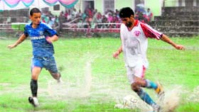 A match of the Lala Nemi Dass Memorial Football League being played amid heavy rain in Dehradun on Monday.