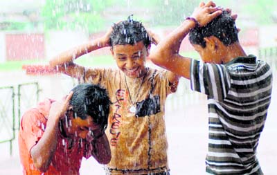 Boys frolic in rain showers in Dehradun on Monday.