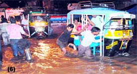 Residents try to get their vehicles out of the water in Haridwar