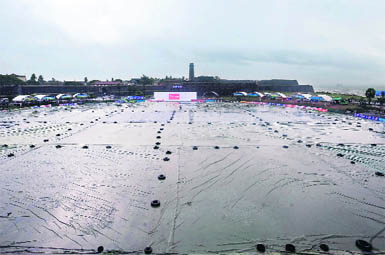 The playing field is seen covered with tarps as rain delays the start of the second day of the first Test between Sri Lanka and India in Galle on Monday.