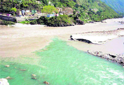The Pindar river (green water) joins the Alaknanda in the Garhwal Himalayas. The Devsari Hydro Electric Project is to be built on the Pindar